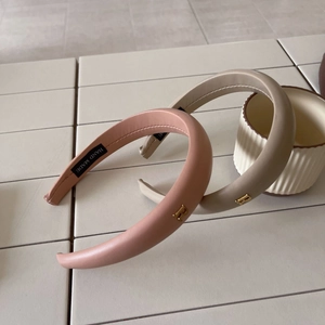 Padded leather headbands in pink and beige with gold metal letter B decoration