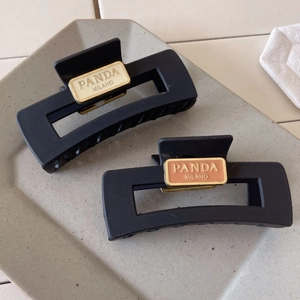 Set of two matte black rectangular hair claws with vintage cream and orange resin accents