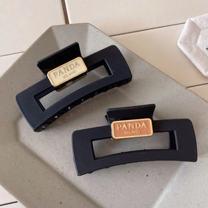 Retro matte black acrylic hair claws with elegant gold-framed enamel nameplates in 2-pack