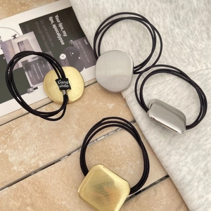 Minimalist elastic hair ties with brushed gold and silver oval metal ornaments