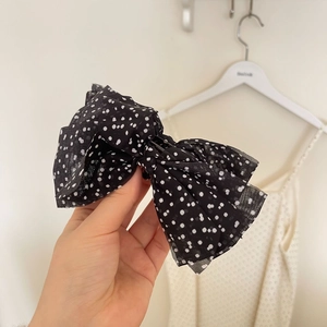 French polka dot bow hair clip for women featuring layered black chiffon and white dots