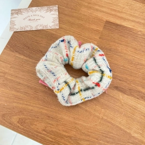 Sweet cream plaid knitted scrunchie hair tie on a wooden background for women