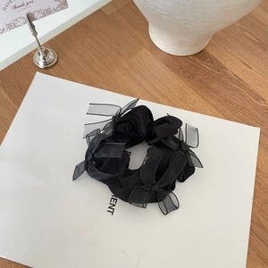 Elegant black scrunchie with satin bows and sheer tulle accents for a stylish look