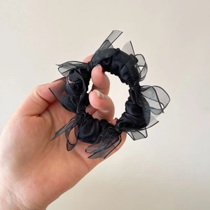 Elegant black satin hair scrunchie with layered organza bow and sheer mesh details
