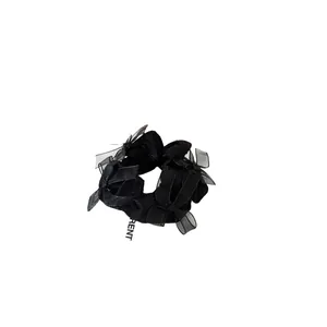 Elegant black satin scrunchie featuring translucent tulle bows with minimalist design