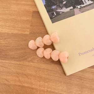 Chouchou en dentelle fleurie avec barrettes coeurs rose pêche sur bureau en bois