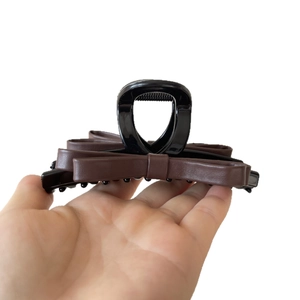 Elegant large brown leather bow hair claw clip for women's bun hairstyle styling