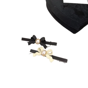 Barrettes nœuds élégantes noires et blanches avec perles et accents dorés