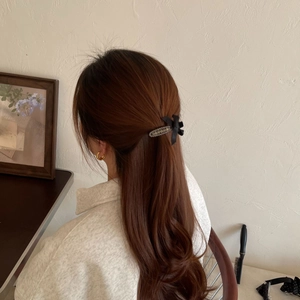 Elegant velvet bow hair clip with silver beads shown on a brunette ponytail