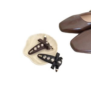 Bow hair clips with rhinestones and leather finish in brown and black colors