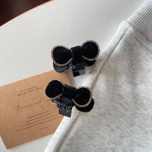 Pair of black velvet bow hair clips with sparkling rhinestone edges for women