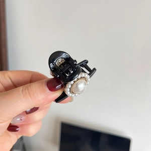 Elegant black hair claw clip featuring large baroque pearl with small pearl halo