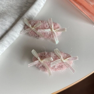 Pair of plush pink mohair hair clips with elegant white ribbon bows for women