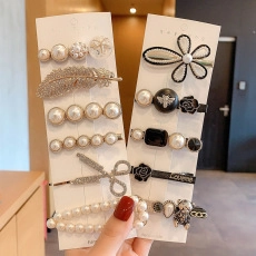 Detail shot of acrylic hair clip set featuring pearls, rhinestones, and metal charms