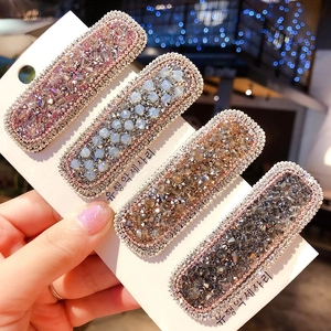 Set di quattro fermagli per capelli in cristallo scintillante in rosa, blu, oro e grigio