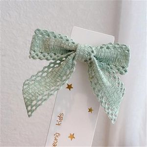 Mint green lace bow hair clip for girls on a star pattern display card