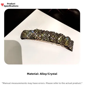 Macro detail of alloy hair clip showing dense dark grey rhinestones and metallic base