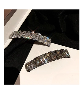 Detailed view of silver and holographic crystal rhinestones on stylish hair clips