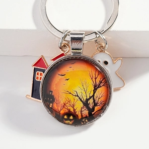 Halloween keychain with pumpkin glass pendant and ghost metal charms on white stairs