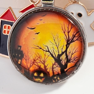 Halloween glass pendant with spooky castle and bats scene in a round metal frame