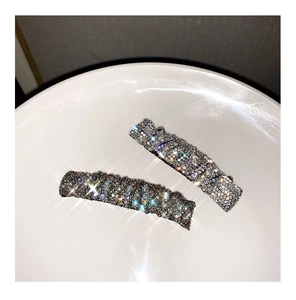 Macro detail of rhinestone hair clips with colorful crystals on a gunmetal base