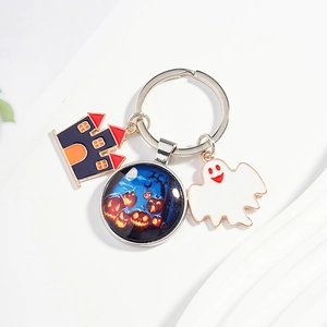 Halloween keychain with purple castle, white ghost, and pumpkin glass dome charms