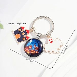Halloween keychain detail with spooky castle, pumpkin charm, and ghost pendant on silver ring