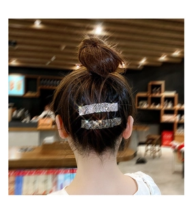 Sparkling crystal hair clips for women shown in a refined bun hairstyle at a cafe