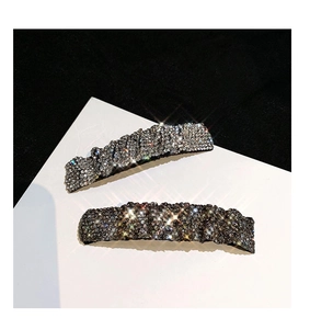 Detail of silver and gunmetal rhinestone hair clips with shimmering crystal inlay