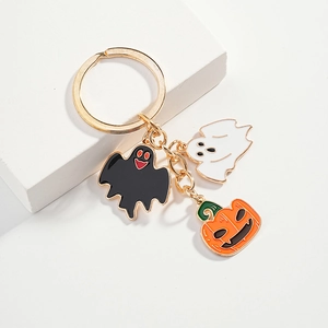 Halloween keychain with enamel ghost and pumpkin charms on a gold metal ring