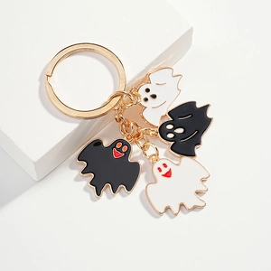 Cute Halloween keychain with four black and white ghost charms on golden metal ring