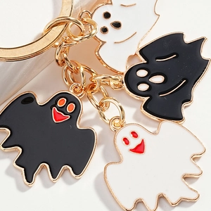 Halloween keychain with four cartoon ghost and bat charms on golden metal chain