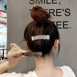 Elegant rhinestone hair clips in silver and grey on model for back-of-head styling