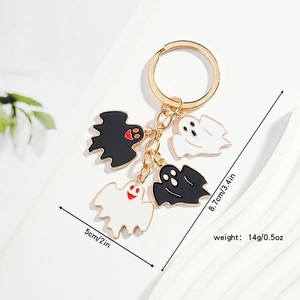 Detail of Halloween ghost keychain charms with gold chain and dimensions on white display