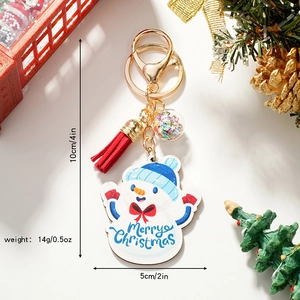 Christmas snowman wooden keychain with red tassel and colorful star bead on festive background