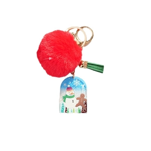 Christmas keychain with red pom pom, green tassel, and acrylic snowman charm on gold ring