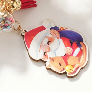 Cartoon Santa Claus keychain with red tassel and sparkling glass ball for holiday decoration