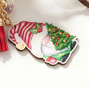 Wooden Christmas gnome keychain with colorful painted tree, red tassel and star glitter ball