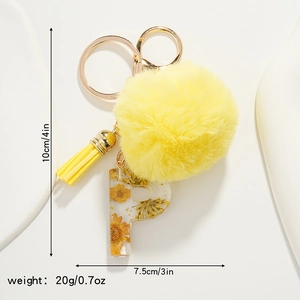 Detail of yellow daisy keychain with plush pom pom, resin letter P and dimensions