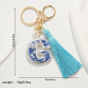 Blue and white porcelain letter G keychain with tassel and dimensions of 12x10cm