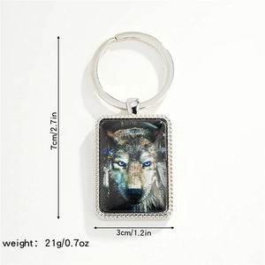 Detail view of rectangular wolf charm keychain with size measurements and diamond texture