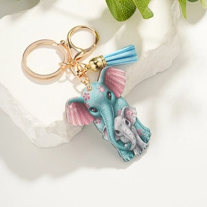Detail of blue elephant acrylic keychain with pink floral pattern and light blue tassel