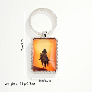 Detail view of western cowboy keychain showing 7cm x 3cm size and silver metal texture