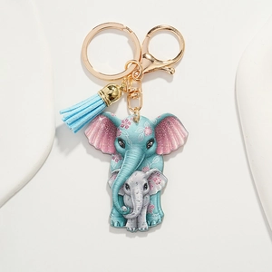 Close-up of mother and child elephant keychain with blue tassel and gold metal clasp