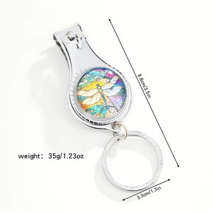 Detail of dragonfly nail clipper keychain showing size measurements and colorful art