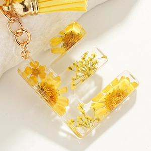 Handmade letter E resin keychain with yellow daisies, gold chain and trendy tassel