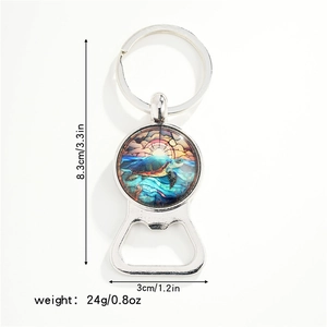 Detail view of turtle pattern glass cabochon on a silver metal bottle opener keychain