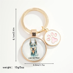 Detail showing gold Doberman keychain with dog paw charm and size measurement data