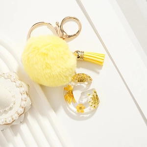 Yellow faux fur pom pom keychain with resin letter G and dried flower tassel charm
