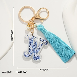 Detailed view of porcelain style letter W keychain with blue tassel and dimensions